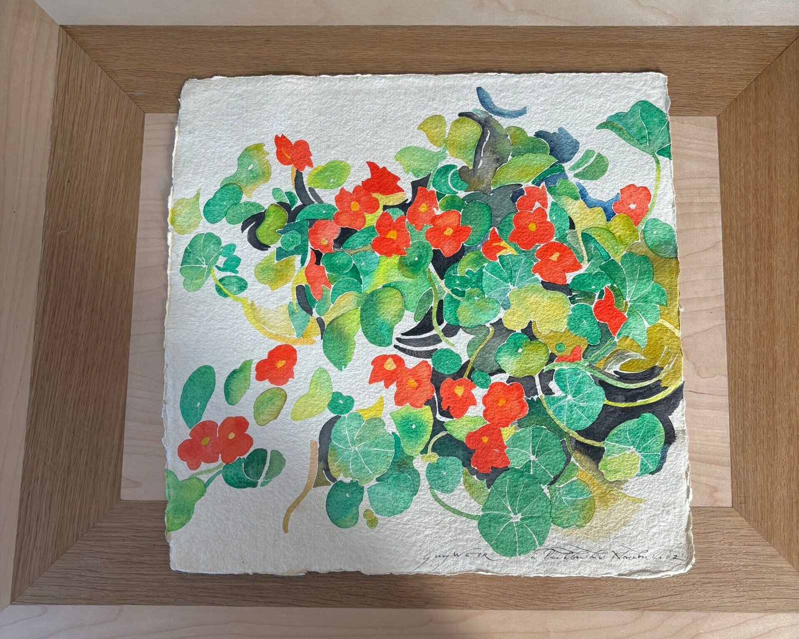 Aquarelle représentant des fleurs rouges et feuillage vert, juste arrivée à l'atelier, pour choisir une baguette d'encadrement